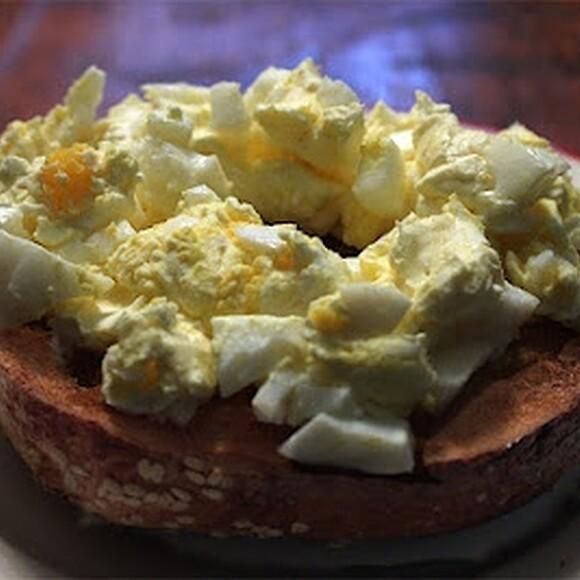 Bagel spread with cream cheese and chopped boiled egg
