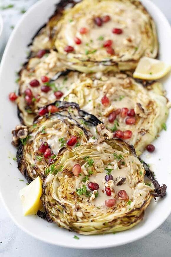 Blistered cabbage steaks with maple tahini and pomegranate