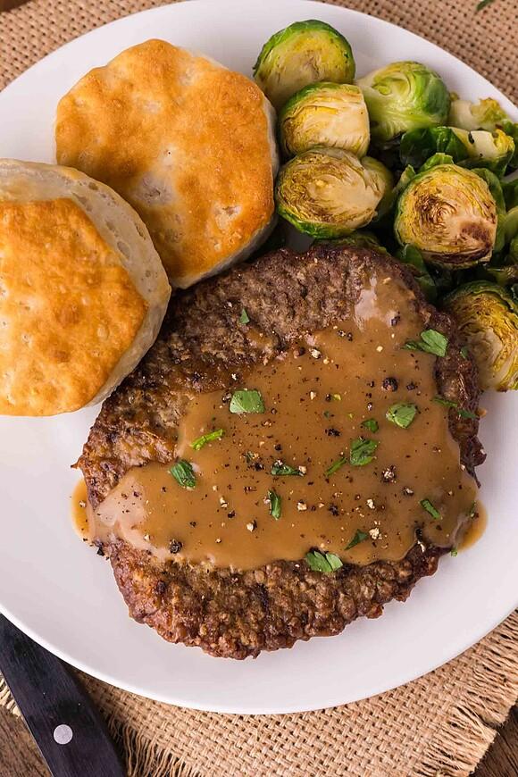 Country fried steak with brown onion gravy