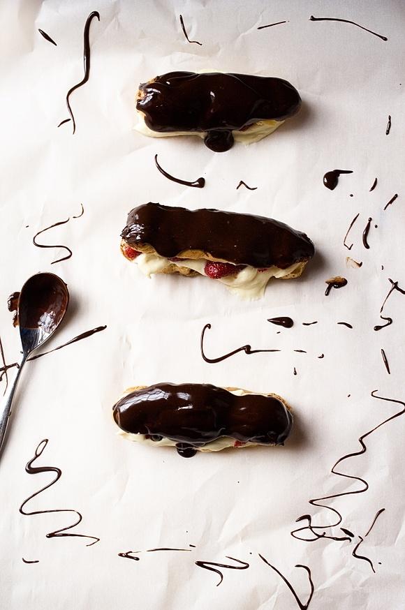 Chocolate éclairs with vanilla pastry cream and strawberries