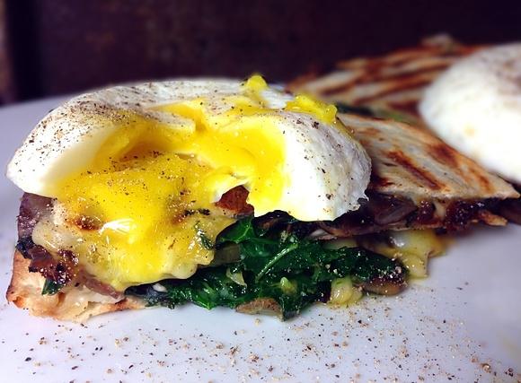 Sautéed kale and mushroom quesadillas with horseradish cream cheese and poached eggs