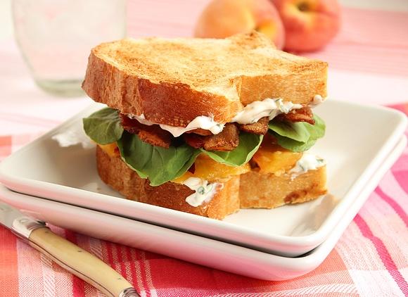 Bacon lettuce and peach sandwich with basil mayo