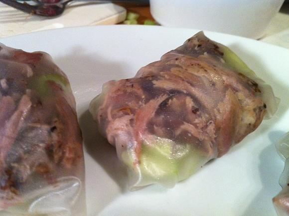 Chinese crispy duck in rice paper wraps with cucumber and spring onion