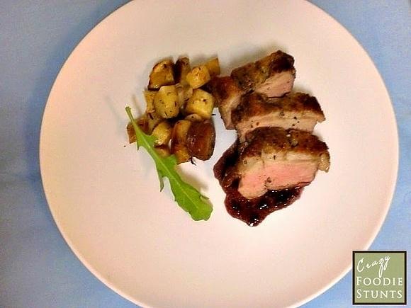 Pan-seared duck breast with red wine reduction and roasted vegetables
