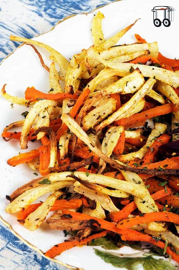 Homemade french fries with parsley and carrots using lovage