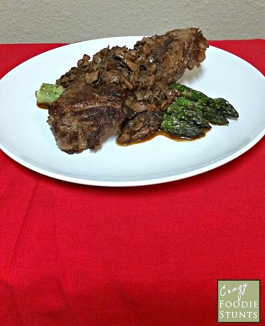 New york strip steak with roasted asparagus and mushroom sauce