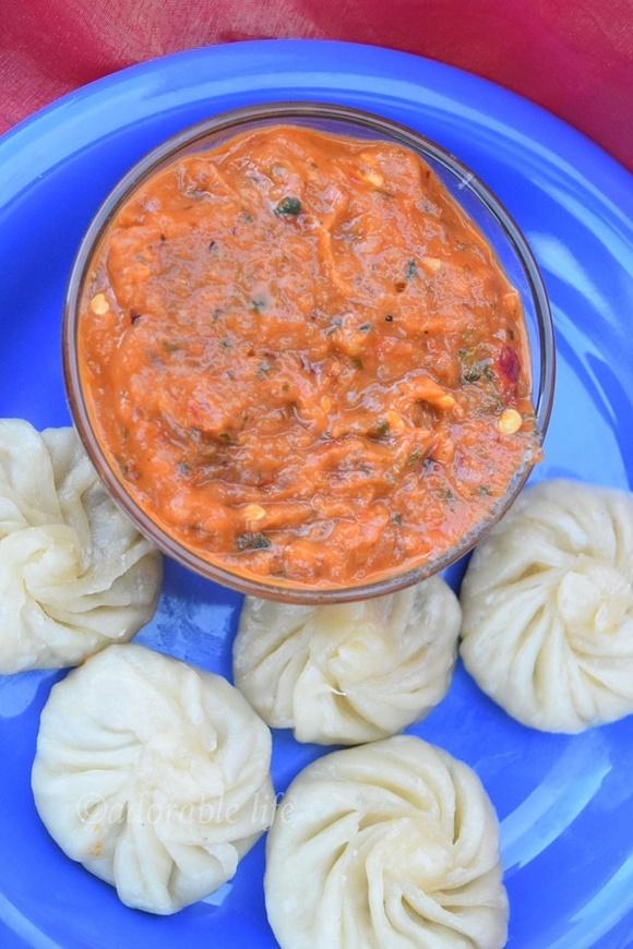Momos with red chilly dip