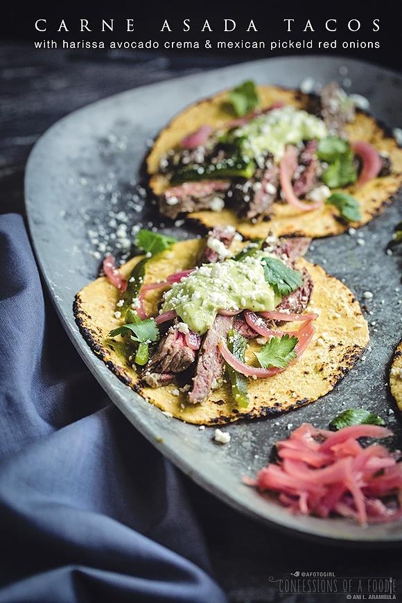 Carne asada tacos with harissa avocado crema and pickled red onions