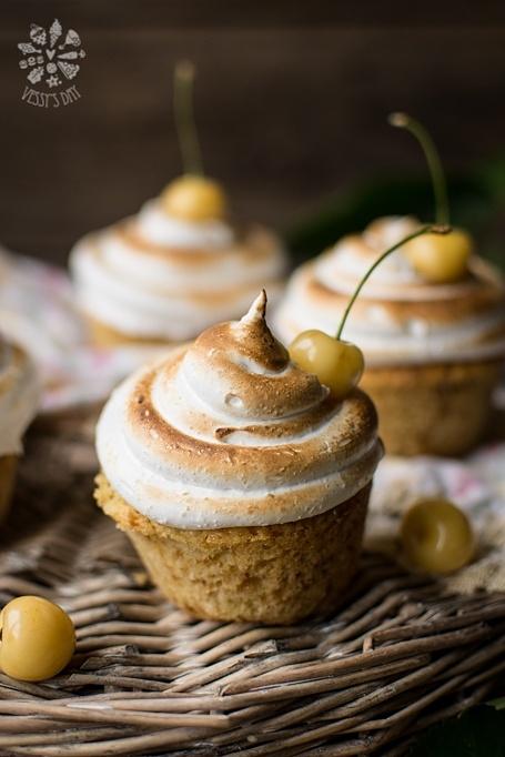 Muffins with white cherries and meringue frosting