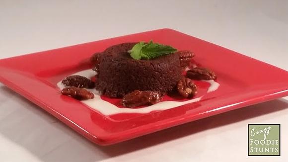 Chocolate indulgence cake with white chocolate sauce and candied pecans