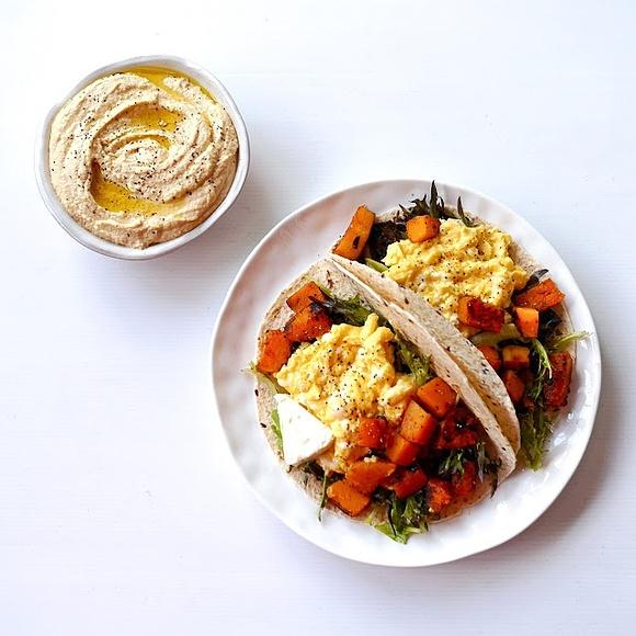 Roasted butternut squash and scrambled eggs tacos with hummus