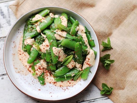 Snap pea salad with mint and tahini harissa dressing