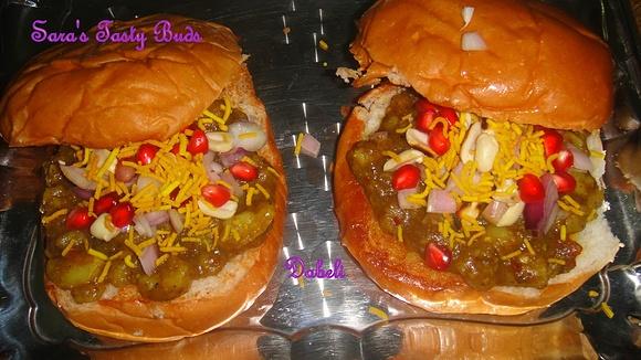 Dabeli indian snack with spiced potato filling and pomegranate